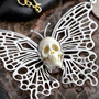 White metal butterfly with bone skull necklace